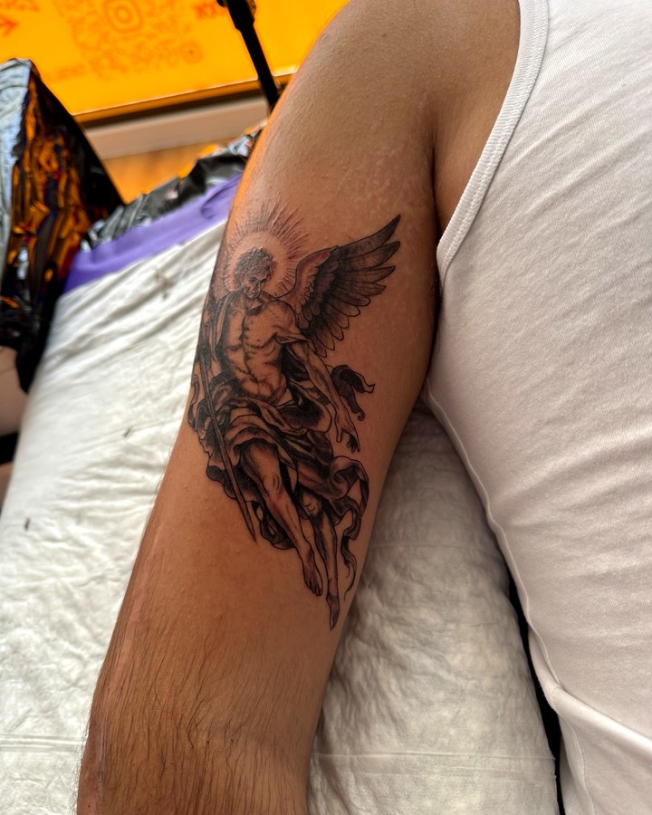 Black and grey angel tattoo on arm